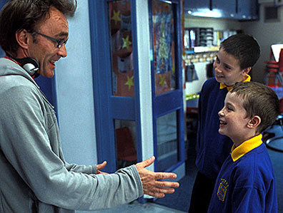 On the set of his new film Millions, director Danny Boyle with actors Alex Etel (Anthony) and Lewis McGibbon (Damian). Courtesy Fox Searchlight Pictures.