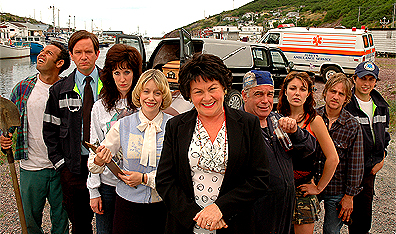 The cast of Hatching, Matching and Dispatching (from left to right): Shaun Majumder (Cyril), Mark McKinney (Todd), Susan Kent (Darlene Furey), Sherry White (Myrna Furey), Mary Walsh (Mamie Lou Furey), Rick Boland (Phonse Furey), Adrianna Maggs (Alma), Joel Hynes (Nick) and Jonny Harris (Troy Furey).