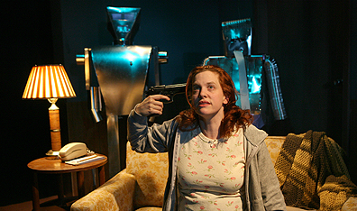 Carolyn Baeumler with co-actor robots in Heddatron. Photo Joan Marcus. Courtesy Les Freres Corbusier.