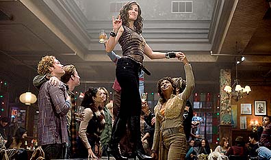 Table dance?: Idina Menzel is centre stage in a scene from Rent. Photo Phil Bray. Courtesy Columbia Pictures.
