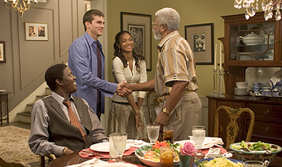 A family dinner in Guess Who: left to right, Bernie Mac, Ashton Kutcher, Zoe Saldana and Hal Williams. Photo Claudette Barius. Courtesy Columbia Pictures/Regency Enterprises.