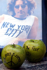 Fruitful message: Apples and a picture of John Lennon are placed on the "Imagine" mosaic in the Strawberry Fields section of New York's Central Park. Photo Mary Altaffer/AP Photo.