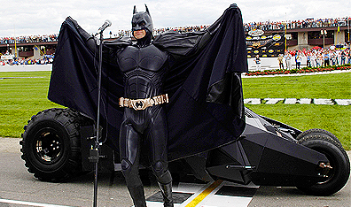 Holy cross-promotion! Batman gives the signal to start the NASCAR Nextel Cup Series Batman Begins 400 in Brooklyn, Michigan. Photo Rusty Jarrett/Getty Images.