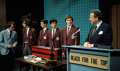 Host Terry Garner congratulates encylopedia-winning contestants on Reach for The Top.
