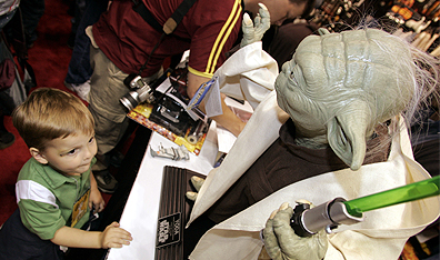 A marketing monster: Three-year-old Max Martin of Indianapolis, looks up to a life-sized Yoda. (AP Photo/Tom Stratman.) 