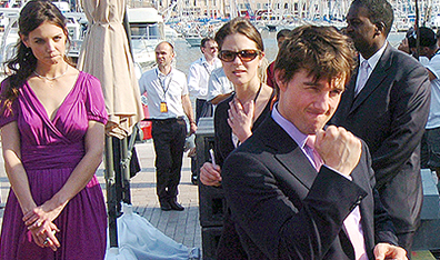 Cruising to victory: Actor Tom Cruise, right, gestures as new fiancee, actress Katie Holmes, left, looks on. Cruise, in France to promote the Steven Spielberg film War of the Worlds, proposed to Holmes earlier on at the Eiffel Tower in Paris. Photo Claude Paris. Courtesy AP Photo.