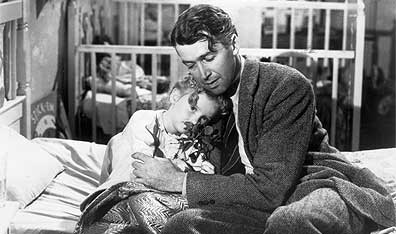 Family man: George Bailey (Jimmy Stewart) hugs daughter Zuzu (Karolyn Grimes) in Frank Capra's 1946 holiday classic, It's a Wonderful Life. Photo Hulton Archive/Getty Images.